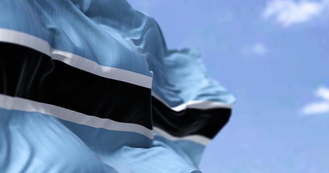 Detail of the national flag of Botswana waving in the wind on a clear day. Democracy and politics. Patriotism. Selective focus. Botswana is a landlocked country in Southern Africa