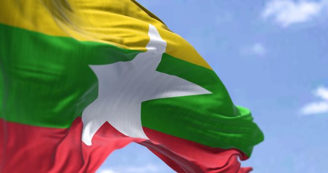Detail of the national flag of Myanmar waving in the wind on a clear day. Democracy and politics. Patriotism. Selective focus. Myanmar is a country in Southeast Asia