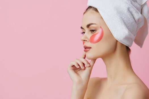 pretty woman pink patches on the face with a towel on the head close-up Lifestyle. High quality photo