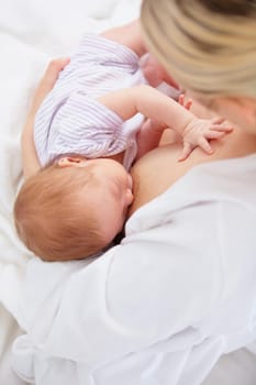 High angle shot of a mother breastfeeding her newborn baby.