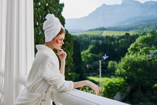 Portrait woman in a white robe the balcony overlooks the mountains unaltered. High quality photo