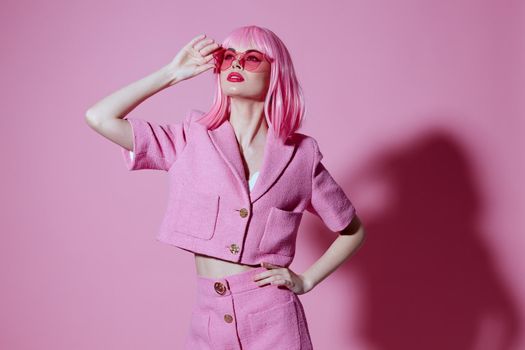 Positive young woman gesturing with hands pink jacket lifestyle glamor monochrome shot unaltered. High quality photo