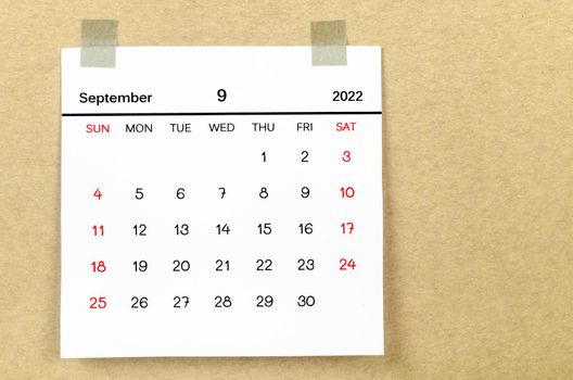 The September 2022 calendar on brown background.