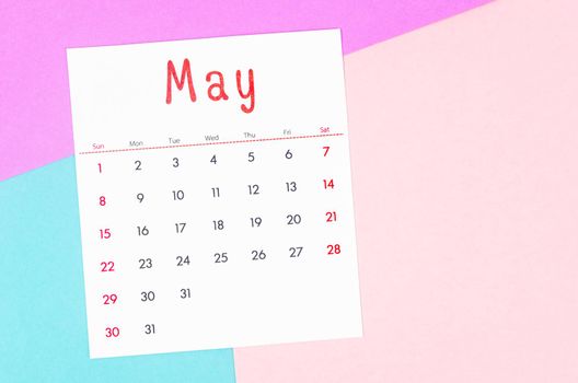 The May 2022 calendar on multicolored background.