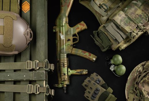 the military ammunition top view of a grenade box, rifle, grenades, bulletproof vest, helmet and other tactical items