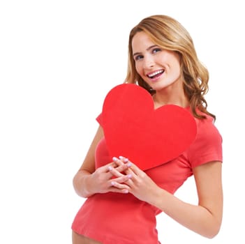 A excited young woman holding a heart-shaped placard while isolated on a white background.