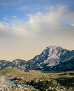 Mountain valley during sunrise. Natural summer landscape. Mountain peak green nature scenery. trail on green hill landscape.