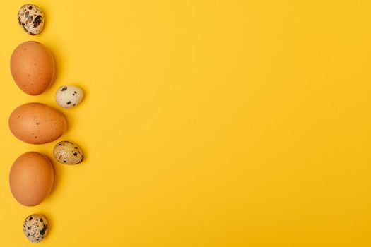 Easter eggs on a yellow background, place for an inscription in the center