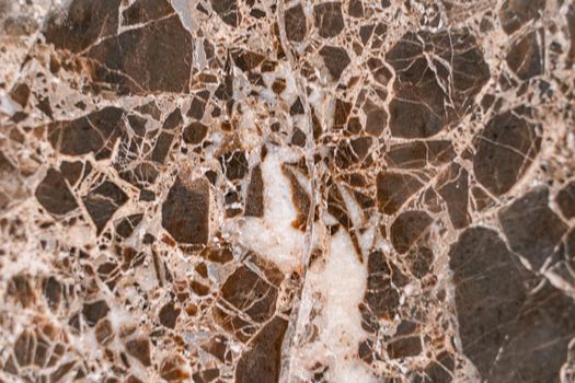Luxurious dark brown marble with light streaks. The polished quartz stone background is naturally striped with a unique pattern, dark concentric stripes.