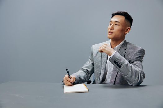 manager with a notepad on the table sits at the office desk executive. High quality photo