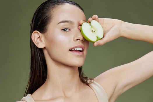 brunette with a green apple smile close-up Lifestyle. High quality photo