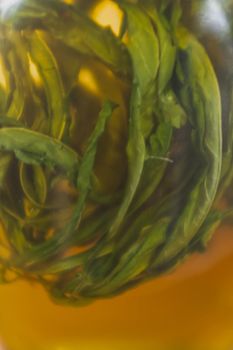 Dried cannabis pickled with honey in bottle .