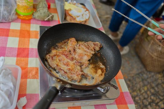 Fried pork in pan .  THAI FOOD