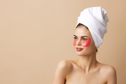 beautiful woman pink patches on the face with a towel on the head close-up Lifestyle. High quality photo