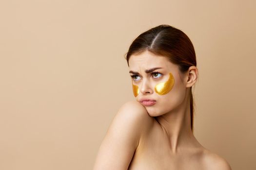 pretty woman skin care face patches bare shoulders hygiene close-up Lifestyle. High quality photo