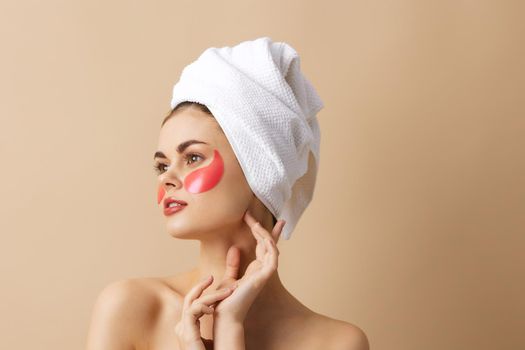 beautiful woman with a towel on his head gesturing with his hands skin care isolated background. High quality photo