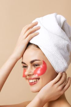 woman pink patches on the face with a towel on the head isolated background. High quality photo