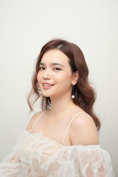 Close-up portrait of beautiful young lady with stylish makeup and curly long healthy hair