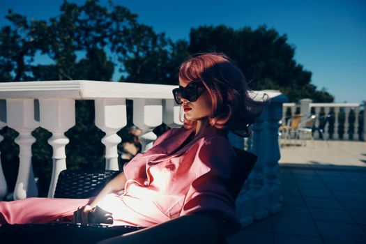 portrait of a young beautiful woman pink hair sunglasses leisure luxury vintage sunny day. High quality photo