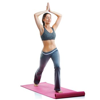 Studio shot of a fit young woman doing yoga isolated on white.