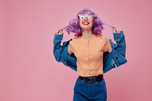 Beauty Fashion woman purple hair fashion glasses denim clothing pink background unaltered. High quality photo