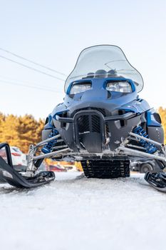 Snowmobile in winter conditions. Snowmobiling in winter in the north. Extreme kind of winter outdoor sport.