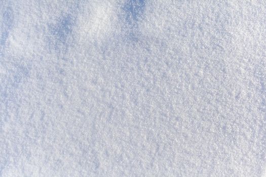 Clean, white snow close-up. Winter background. Snow surface. Fresh fluffy white snow texture.White snowflakes. High quality photo