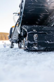 The back of the snowmobile in winter. Riding in the snow on a snowmobile. Rear suspension of a snowmobile.Snowmobile in winter conditions. Extreme kind of winter outdoor sport. 