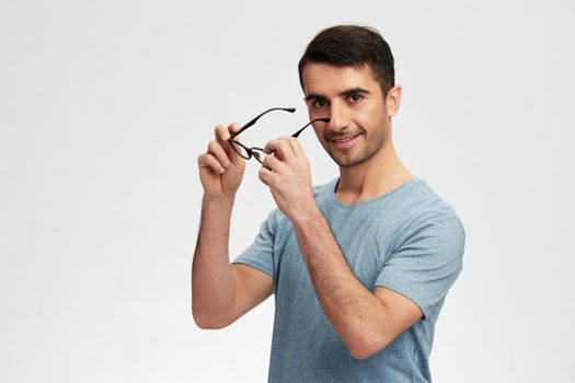 Cheerful man in glasses casual wear posing emotions cropped view. High quality photo