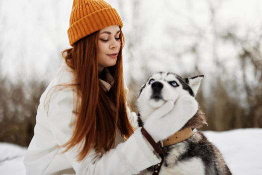 woman with dog outdoor games snow fun travel fresh air. High quality photo