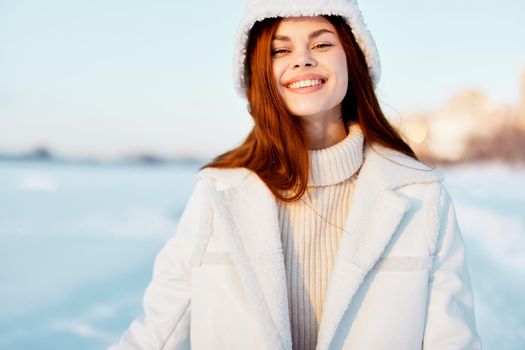 pretty woman red hair snow field winter clothes Fresh air. High quality photo