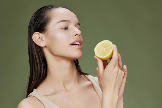 portrait woman eating lemon in hands smile vitamins diet isolated background. High quality photo