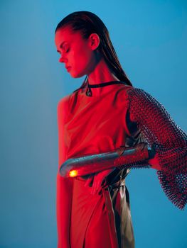 photo pretty woman Glamor posing red light metal armor on hand isolated background. High quality photo