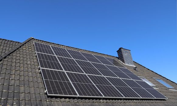 Solar panels producing clean energy on a roof of a residential house