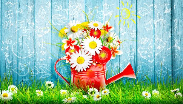 Spring flowers in watering can. Gardening tools and equipment.
