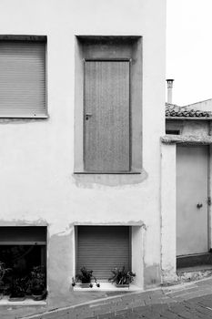 Abstract facade with nonsense and dangerous door on top without staircase in Benifato village, Alicante