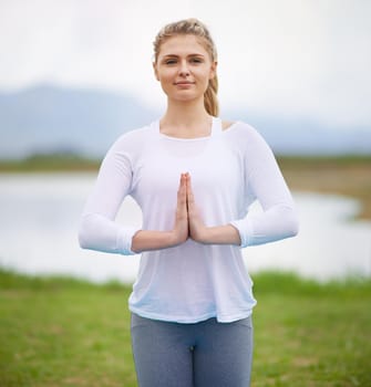 Shot of a young woman doing yoga in the outdoors.