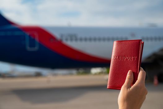 A woman gets on a plane and holds a passport.