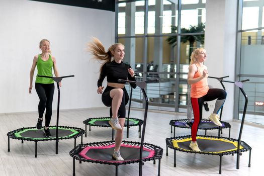Trampoline for fitness girls are engaged in professional sports, the concept of a healthy lifestyle jumping trampoline woman fitness sport girl, for workout active for activity and body movement, club vitality. Sportswear fly bounce, center