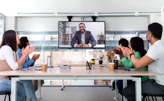 Group of multiracial coworkers on videocall with boss clap together celebrating business success. Business concept.