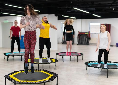 Women's and men's group on a sports trampoline, fitness training, healthy life - a concept trampoline group batut instructor healthy, from lifestyle athletic from sporty for young shaping, wellness happiness. Studio beauty athlete, exercising