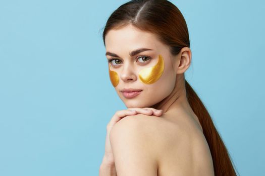 woman golden patches on the face isolated background. High quality photo