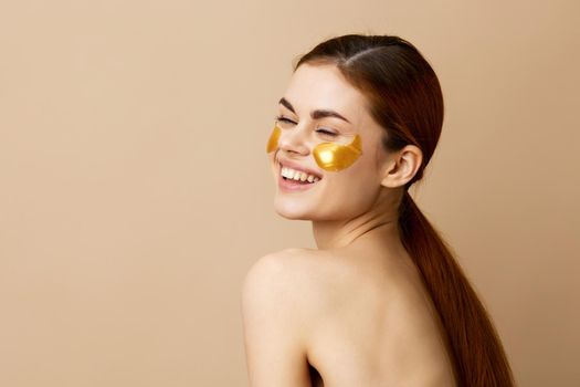 pretty woman golden patches on the face isolated background. High quality photo