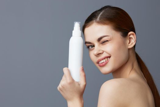 woman body lotion rejuvenation cosmetics Gray background. High quality photo