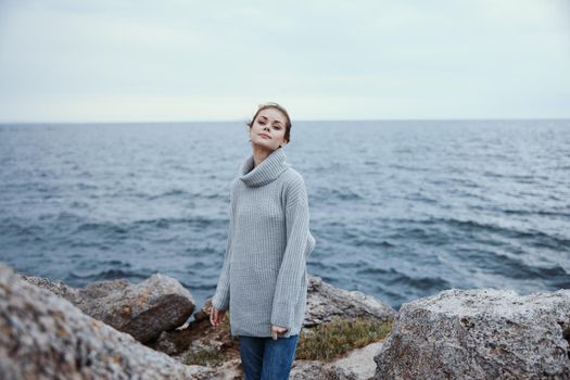 beautiful woman beach tourism cloudy weather stone coast unaltered. High quality photo