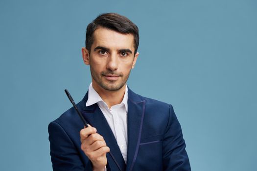 businessman portrait pen in hand manager's workflow blue background. High quality photo