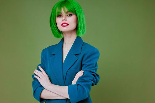 Pretty young female Glamor green wig red lips blue jacket green background unaltered. High quality photo