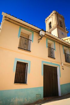 Bolulla, Alicante, Spain- February 6, 2022: Facades of Bolulla village and San Jose church tower in the background