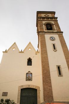 Benifato, Alicante, Spain- February 4, 2022: Main facade and entrance of San Miguel Arcangel church in Benifato town