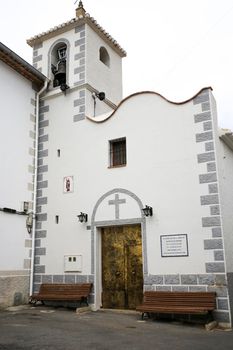 Abdet, Alicante, Spain- February 5, 2022: Main entrance of San Vicente Ferrer church in Abdet town on a cloudy day